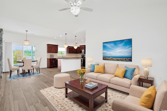 living area with recessed lighting and ceiling fan