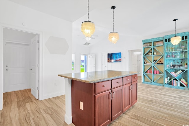 kitchen with a notable chandelier, visible vents, baseboards, vaulted ceiling, and pendant lighting