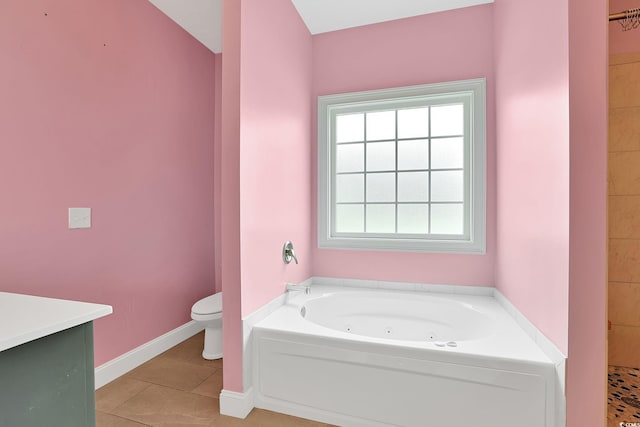 bathroom with baseboards, toilet, a whirlpool tub, tile patterned floors, and vanity