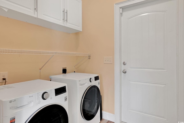 laundry area with cabinet space and washer and clothes dryer