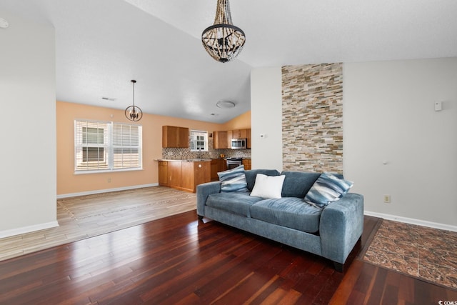 408 Chesterfield Ct, Myrtle Beach, SC 29577 - living room with a chandelier, light wood-type flooring, lofted ceiling, and baseboards