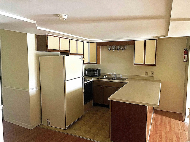 500 Fairway Village Dr Unit 6E, Myrtle Beach, SC 29588 - kitchen with white appliances, a peninsula, light countertops, and dark wood-type flooring
