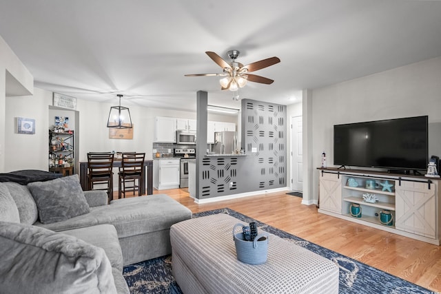 2262 Andover Dr Unit E, Surfside Beach, SC 29575 - living area with light wood-style flooring, ceiling fan, and baseboards
