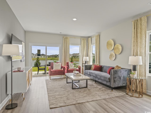 living room featuring recessed lighting, baseboards, and wood finished floors