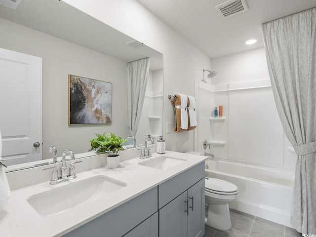 bathroom featuring shower / bath combo with shower curtain, toilet, visible vents, and a sink