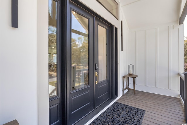 doorway to property with board and batten siding and french doors