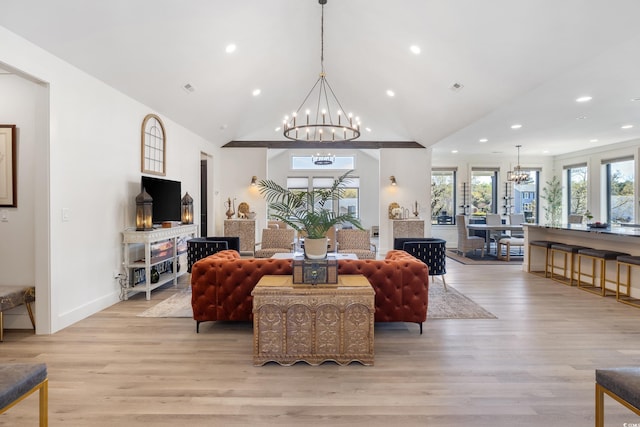 living area featuring recessed lighting, an inviting chandelier, plenty of natural light, and light wood-style flooring