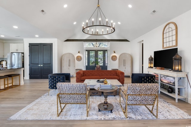 living room with visible vents, light wood-style floors, and a chandelier