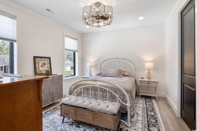 bedroom featuring visible vents, baseboards, recessed lighting, a chandelier, and light wood-style flooring