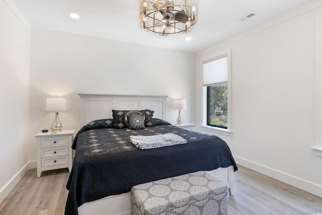 bedroom featuring visible vents, baseboards, light wood finished floors, a chandelier, and recessed lighting