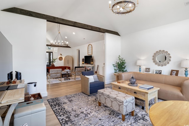 living room with a chandelier, lofted ceiling with beams, wood finished floors, and visible vents