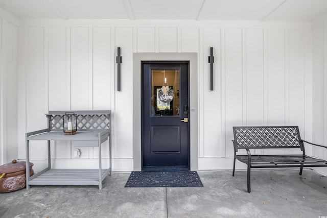 doorway to property featuring board and batten siding