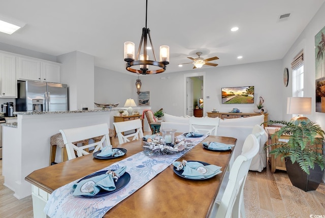 dining space with recessed lighting, visible vents, ceiling fan with notable chandelier, and light wood-style floors