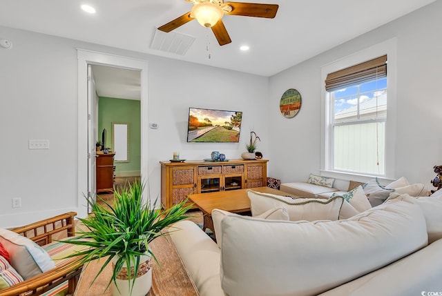 living room with a ceiling fan, visible vents, and recessed lighting