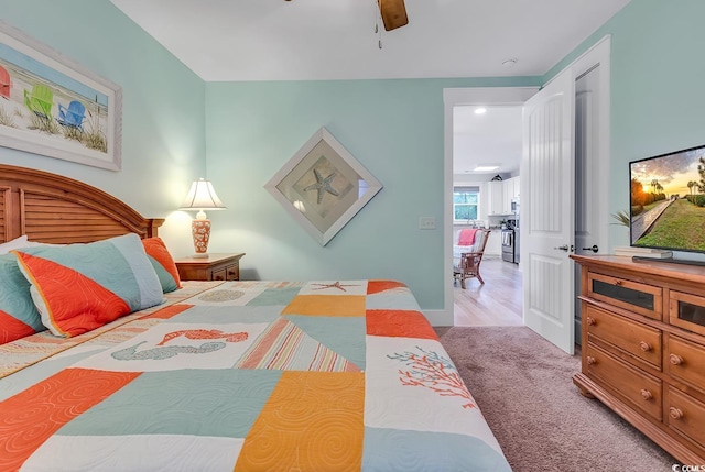 carpeted bedroom featuring baseboards and ceiling fan