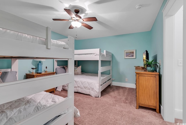 bedroom with baseboards, ceiling fan, and light colored carpet