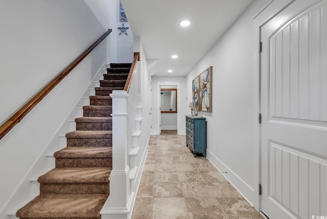 stairs featuring baseboards, recessed lighting, and stone finish flooring