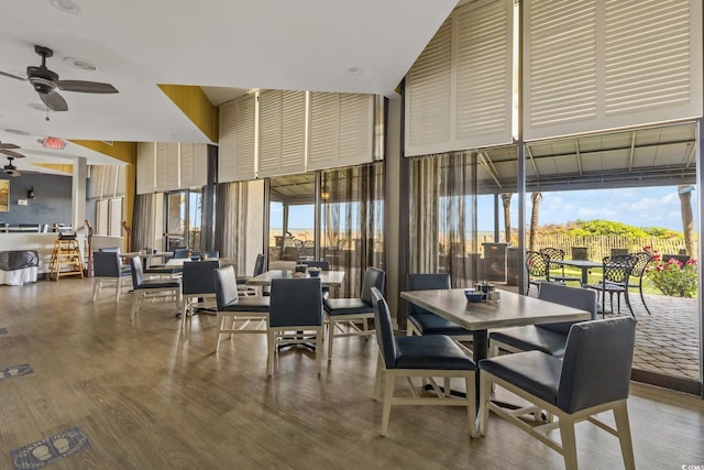7100 Ocean Blvd N Unit 1425, Myrtle Beach, SC 29572 - dining space featuring a ceiling fan, floor to ceiling windows, wood finished floors, and a towering ceiling