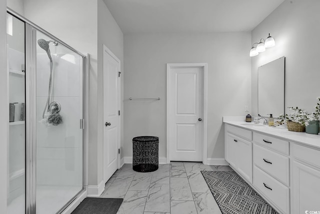full bathroom with baseboards, a shower stall, marble finish floor, and vanity