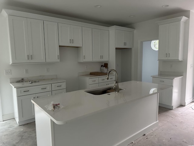2212 Dykman Cir, Little River, SC 29566 - kitchen featuring a sink, a kitchen island with sink, white cabinetry, and baseboards