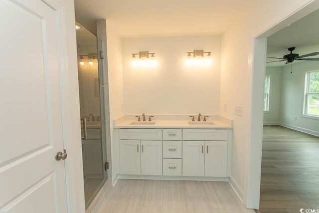 2212 Dykman Cir, Little River, SC 29566 - bathroom with baseboards, double vanity, and ceiling fan