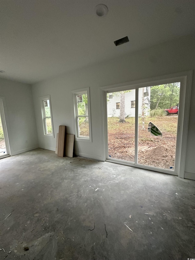 unfurnished room featuring concrete flooring