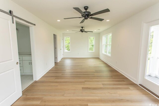 2212 Dykman Cir, Little River, SC 29566 - empty room featuring recessed lighting, light wood-style flooring, a barn door, and ceiling fan