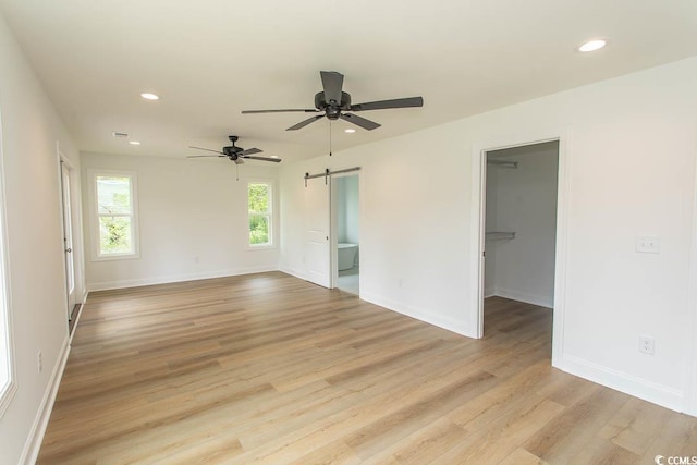 2212 Dykman Cir, Little River, SC 29566 - unfurnished room featuring a barn door, recessed lighting, light wood finished floors, ceiling fan, and baseboards