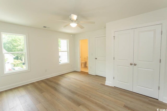 2212 Dykman Cir, Little River, SC 29566 - unfurnished bedroom with baseboards, light wood-style floors, connected bathroom, a closet, and ceiling fan