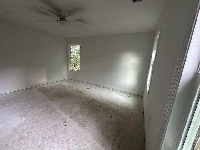 2212 Dykman Cir, Little River, SC 29566 - unfurnished room with a ceiling fan, concrete floors, and baseboards