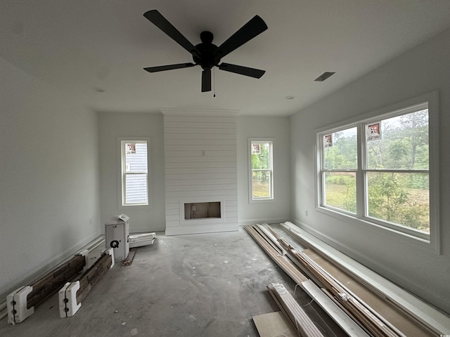 2212 Dykman Cir, Little River, SC 29566 - unfurnished living room featuring a large fireplace, a ceiling fan, and concrete floors