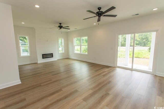 2212 Dykman Cir, Little River, SC 29566 - unfurnished living room featuring ceiling fan, baseboards, wood finished floors, recessed lighting, and a large fireplace