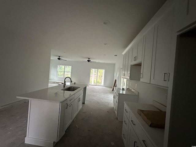 2212 Dykman Cir, Little River, SC 29566 - kitchen featuring a sink, cooktop, a kitchen island with sink, white cabinets, and ceiling fan