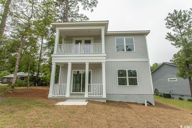 2212 Dykman Cir, Little River, SC 29566 - rear view of house with a balcony, a porch, central AC, and a lawn