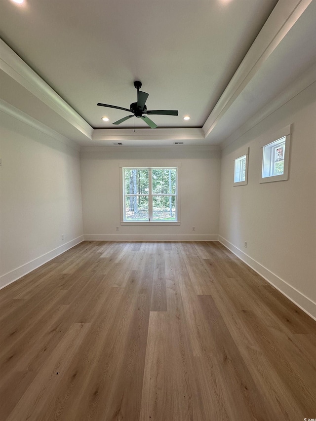 924 Morrall Dr, North Myrtle Beach, SC 29582 - empty room with a raised ceiling, light wood-style flooring, ceiling fan, and recessed lighting