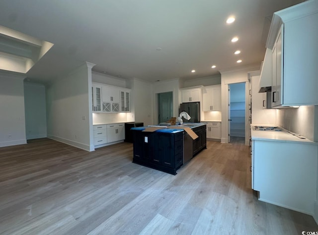 924 Morrall Dr, North Myrtle Beach, SC 29582 - kitchen featuring crown molding, light wood finished floors, fridge, a kitchen island, and white cabinets