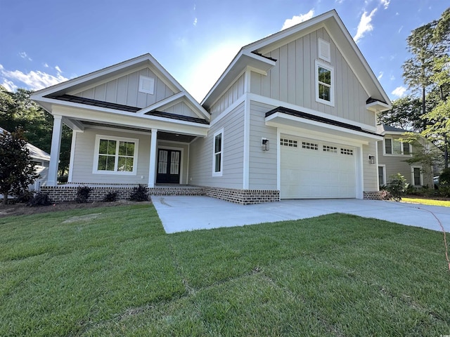 924 Morrall Dr, North Myrtle Beach, SC 29582 - view of front of house with board and batten siding, an attached garage, driveway, and a front yard