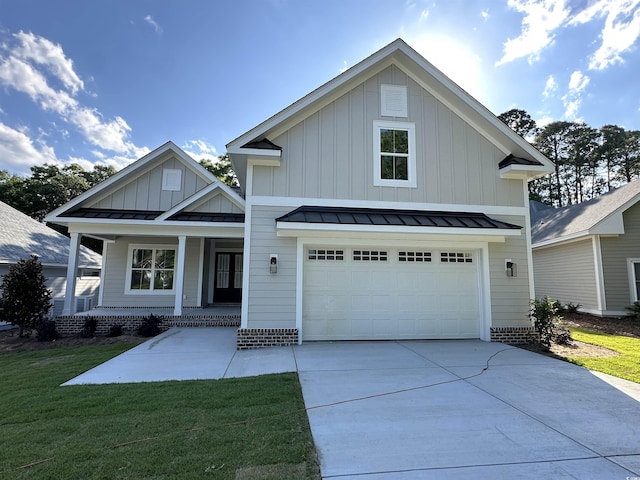 924 Morrall Dr, North Myrtle Beach, SC 29582 - view of front of property featuring board and batten siding, a standing seam roof, a porch, and driveway