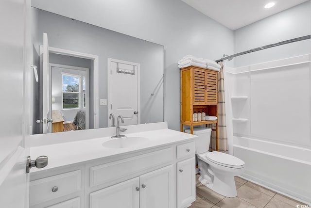 bathroom featuring toilet, shower / washtub combination, tile patterned flooring, and vanity