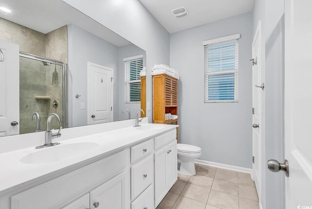 full bathroom featuring a sink, baseboards, a stall shower, and double vanity
