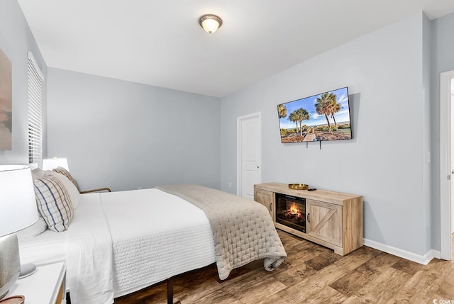 bedroom with baseboards and light wood finished floors