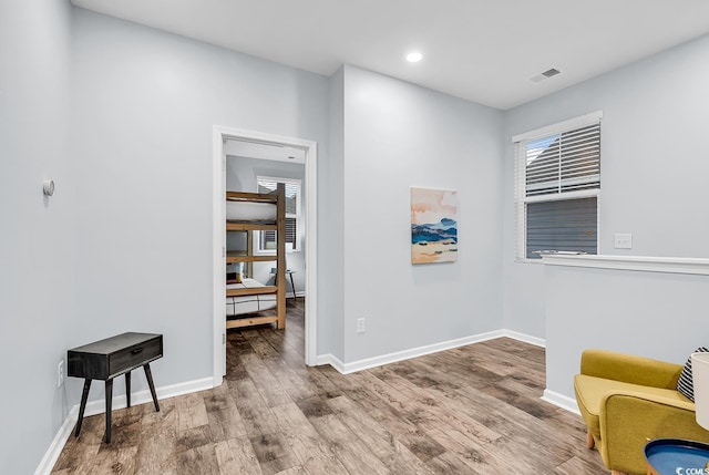 living area featuring baseboards and wood finished floors