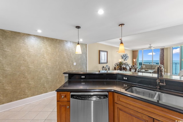 kitchen featuring brown cabinetry, a sink, dishwasher, and dark countertops