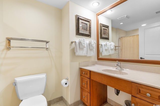 bathroom with visible vents, baseboards, vanity, toilet, and recessed lighting
