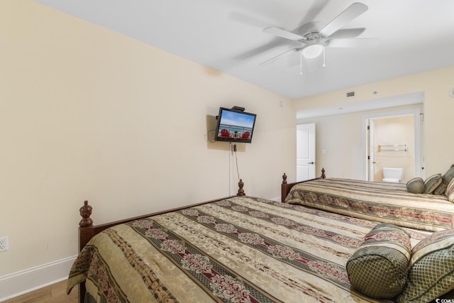 bedroom with baseboards, ceiling fan, wood finished floors, and visible vents