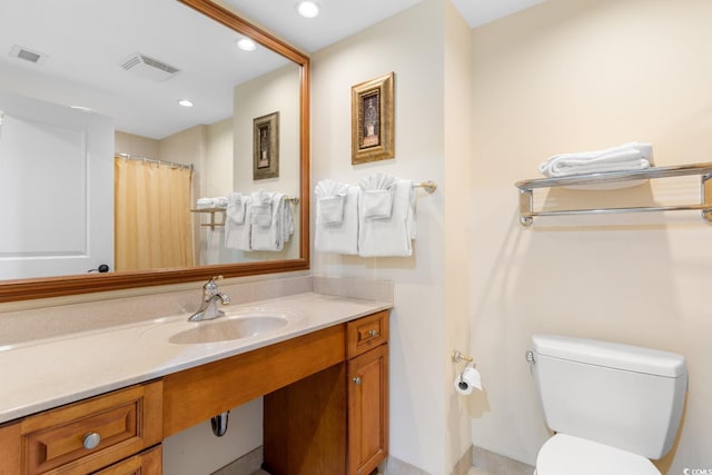 full bathroom featuring recessed lighting, vanity, toilet, and visible vents