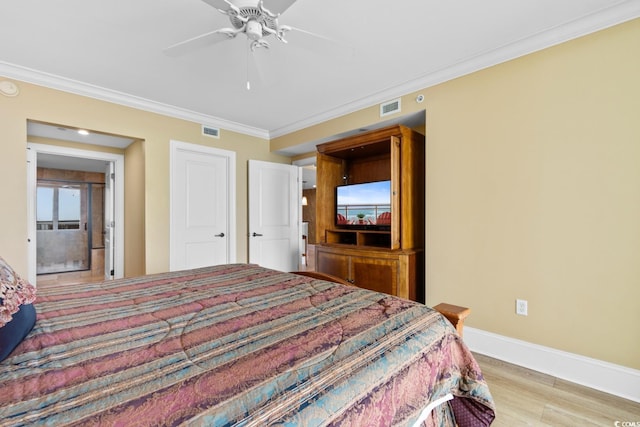 bedroom featuring visible vents, ornamental molding, baseboards, and wood finished floors