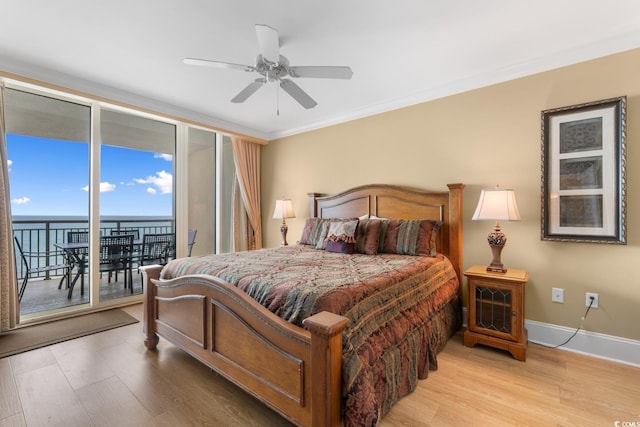 bedroom with access to outside, light wood-style floors, baseboards, ornamental molding, and expansive windows