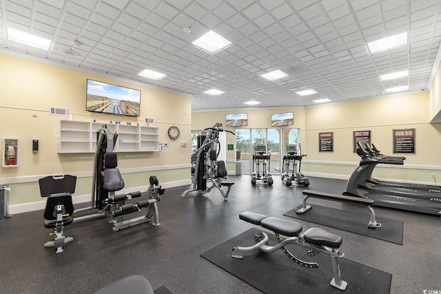 workout area featuring baseboards, visible vents, and a drop ceiling