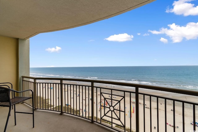 balcony with a view of the beach and a water view